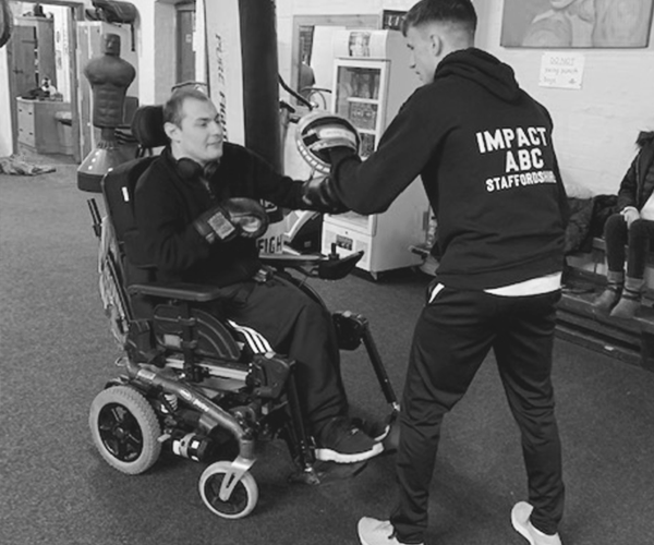 Inclusive boxing coaching session with a wheelchair user